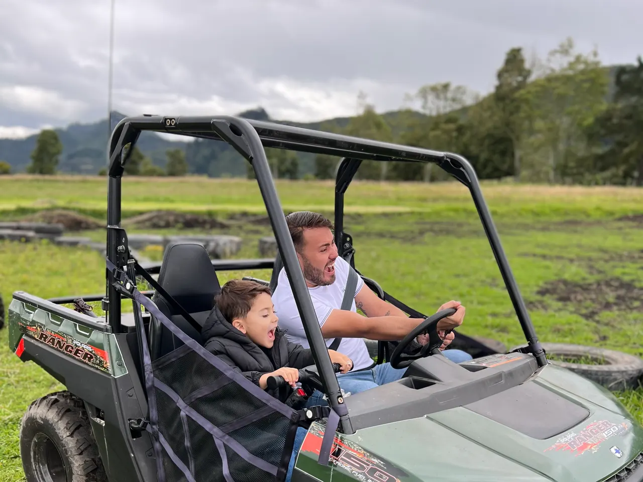 Adult and child riding a buggy at the park