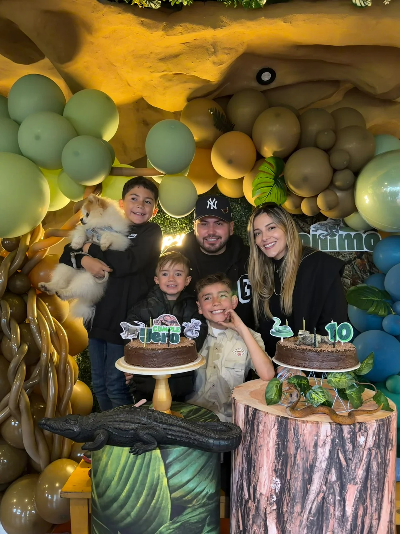 Family celebrating a birthday with dinosaur decorations