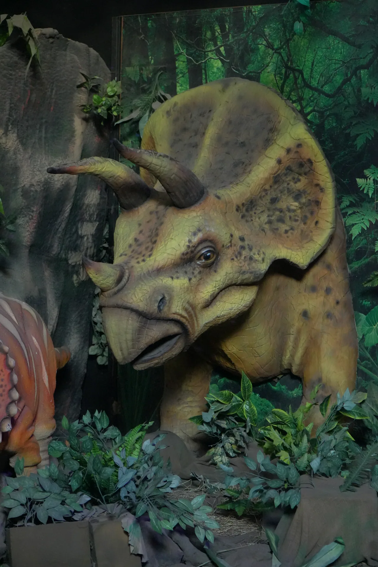 Triceratops figure among plants in Jurassic World